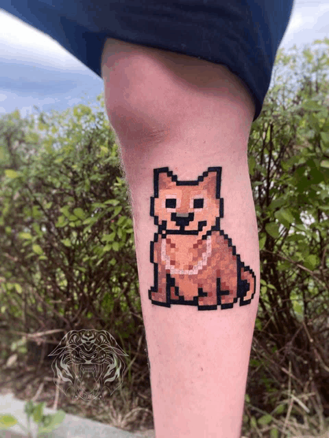 a pixel art tattoo of a dog is on a person 's leg