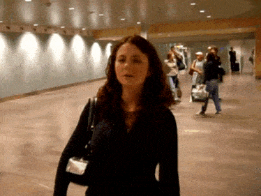 a woman in a black jacket with a name tag on her neck