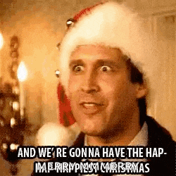 a man wearing a santa hat is saying `` and we 're gonna have the hap merry christmas '' .