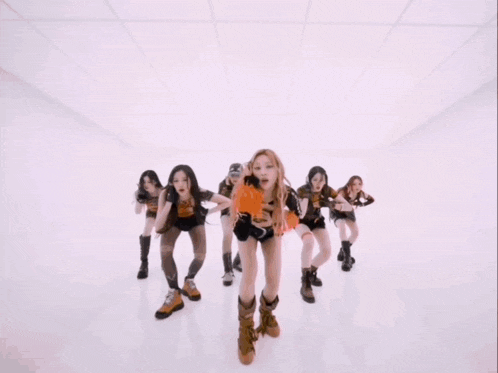 a group of girls are dancing in a pink room and one of them is wearing a top that says " palm angels "