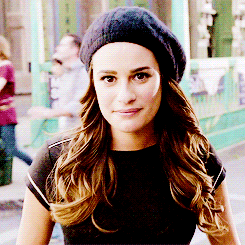 a woman wearing a black hat and a black top
