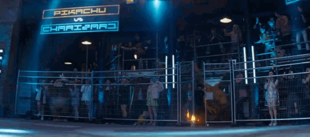 a crowd of people watching a fight between pikachu and charizard in front of a sign that says pikachu vs charizard