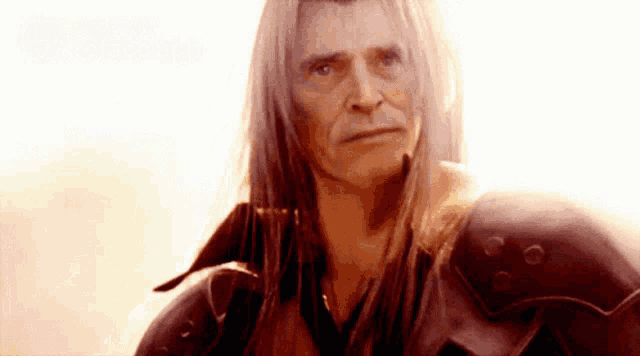 a man with long white hair is wearing a red armor .