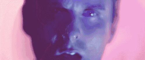 a close up of a man 's face with a pink background and a purple background .