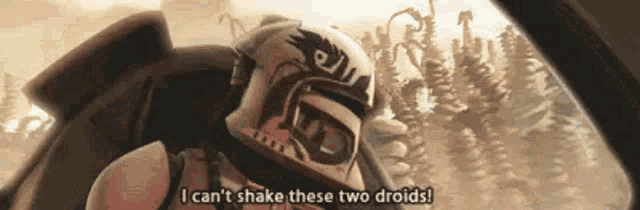 a man in a helmet is sitting in a car and saying `` i can 't shake these two droids ''