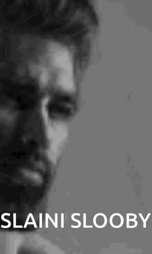 a black and white photo of a man with the words slaini slooby written on the bottom