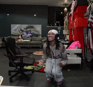 a man wearing headphones is dancing in a living room with a couch that says spurs