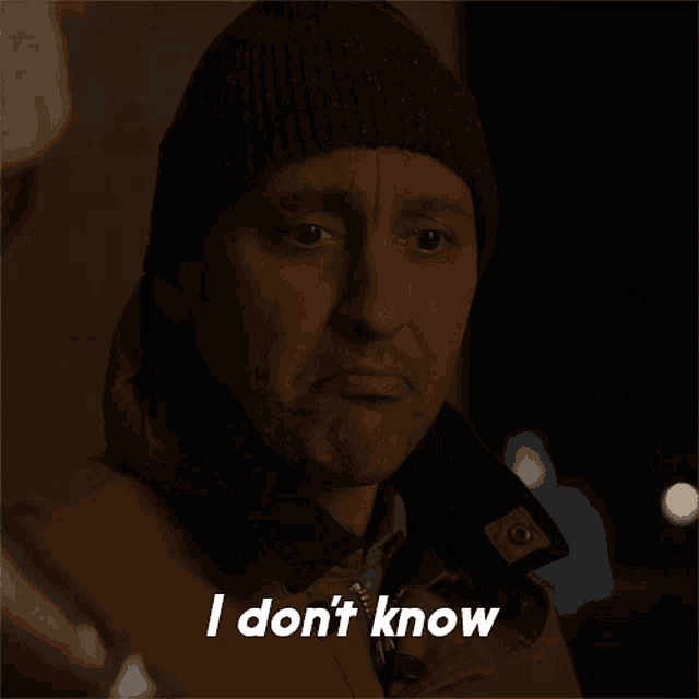 a man wearing a beanie and a jacket says i don 't know