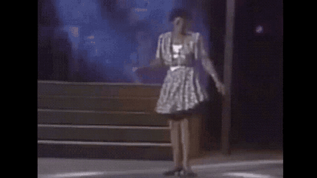 a woman in a striped dress is walking down stairs