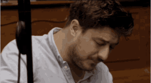 a man with a beard wearing a light blue shirt