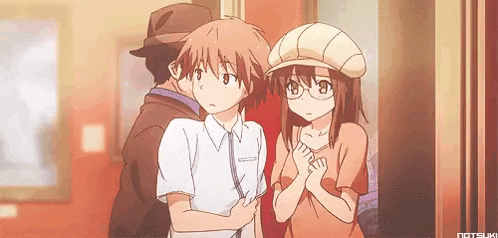 a man and a girl are standing next to each other in a room .