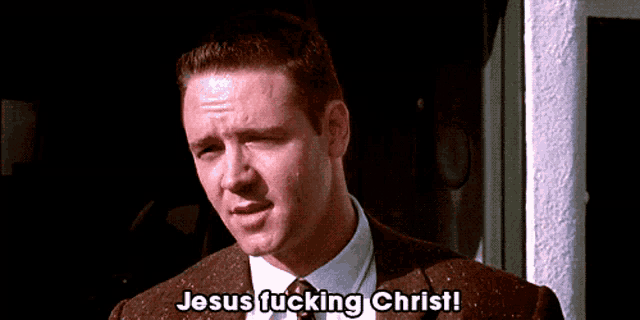a man in a suit and tie is saying " jesus fucking christ "