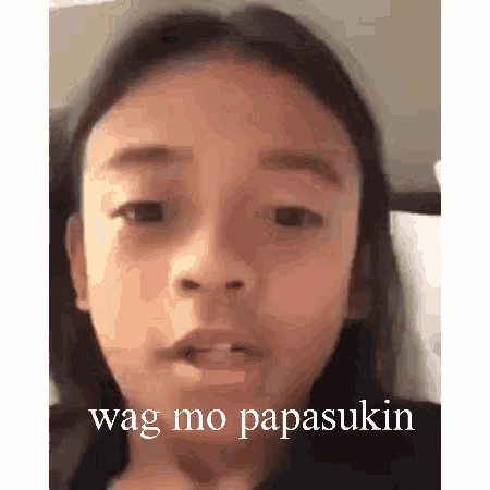 a young girl is making a funny face with the words wag mo papasukin .