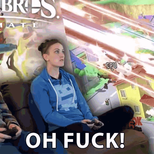 a woman sits on a couch playing a video game with the words oh fuck on the bottom