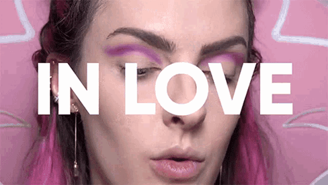 a close up of a woman 's face with the words " in love " above her