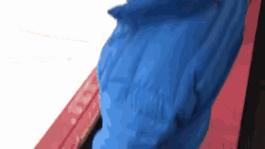 a close up of a blue object on a red background