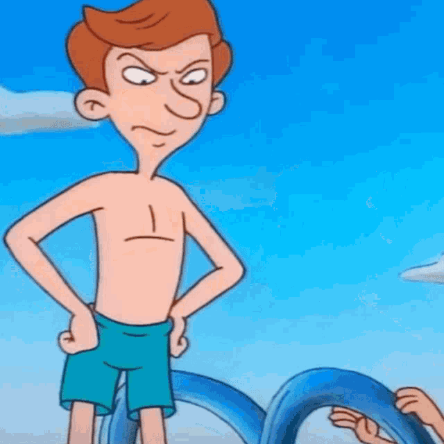 a shirtless cartoon character is standing on a beach with his hands on his hips and making a funny face .