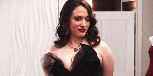 a woman in a black dress with a necklace around her neck