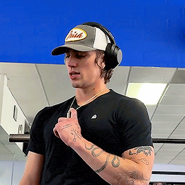 a man wearing headphones and a hat that says brian on it