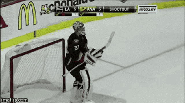 a hockey game is being played and the goalie is wearing a ccm jersey