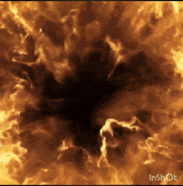 an inshot video of a fire explosion with a black hole in the middle