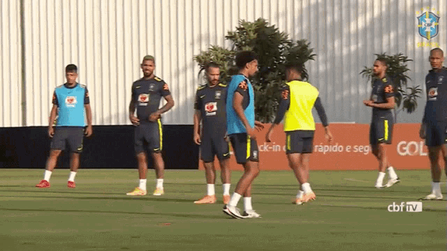 a group of soccer players are standing on a field with a cbn tv logo in the background
