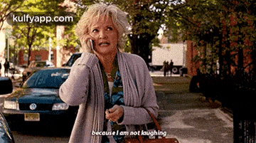 a woman is talking on a cell phone and saying because i am not laughing