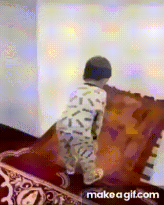 a young boy in pajamas is standing on a rug .