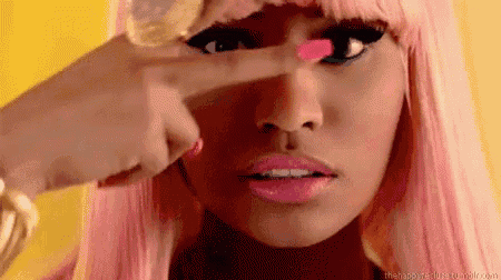 a close up of a woman 's face with pink nails and pink lips .