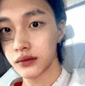 a close up of a young woman 's face while sitting in a car .