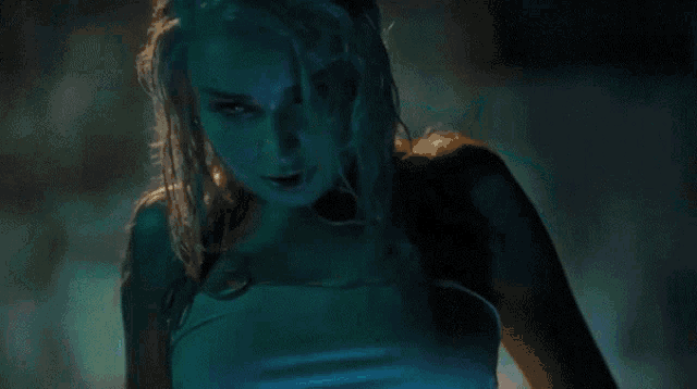 a woman with wet hair and a blue background