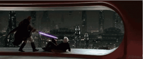 a man is holding a purple lightsaber while another man is laying on the floor