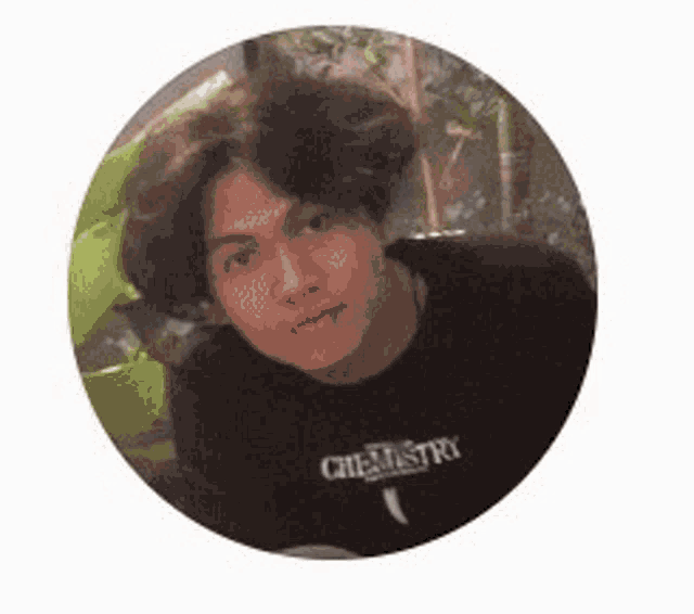 a young man with long hair is standing in a circle .