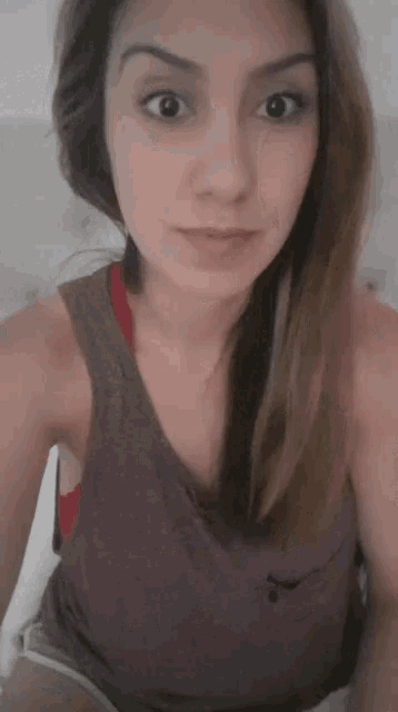 a woman is taking a selfie with her eyes wide open