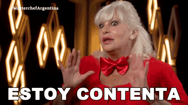a woman wearing a red dress and a red bow tie says estoy contenta