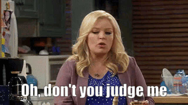 a woman is sitting at a table holding a glass of wine and saying `` oh , don t you judge me ''