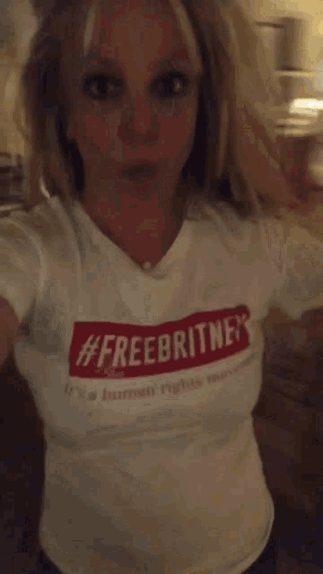 a woman wearing a t-shirt that says #freebritney on it