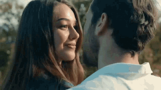 a man and a woman are looking into each other 's eyes .