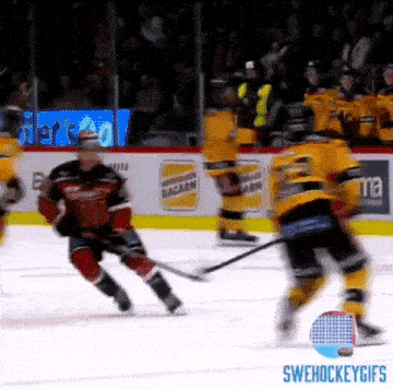 a hockey game is being played on a ice rink