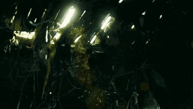 a dark room with a light shining through a broken glass