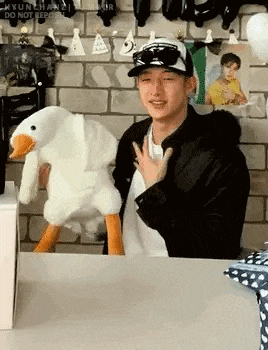a man is holding a stuffed duck in his hands .
