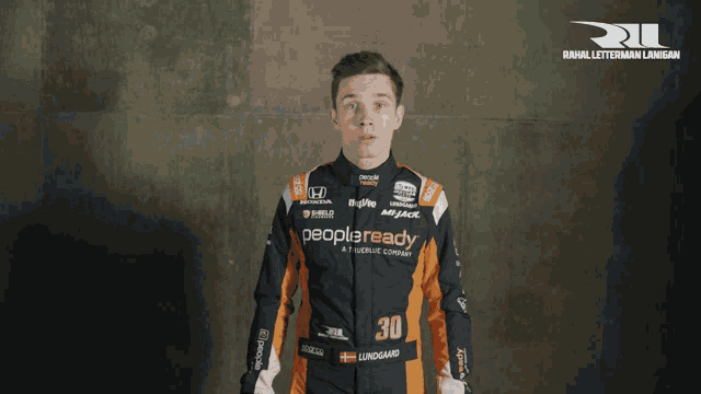 a man in a race suit with the word peopleready on his shirt