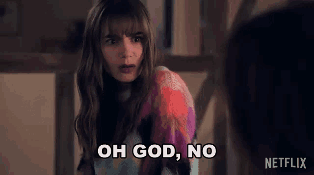 a woman in a colorful sweater is making a funny face and says `` oh god , no '' .