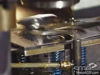 a close up of a machine that is making a piece of metal