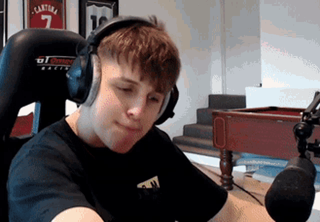 a young man wearing headphones with the number 7 on the back of his shirt