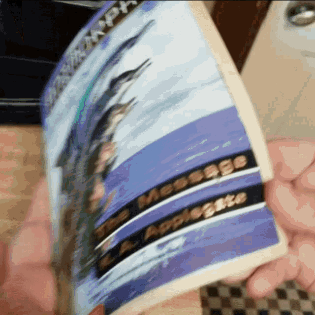 a person is holding a piece of paper that says " the message "