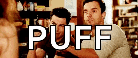 two men are sitting next to each other in a room with the word puff written on the screen .