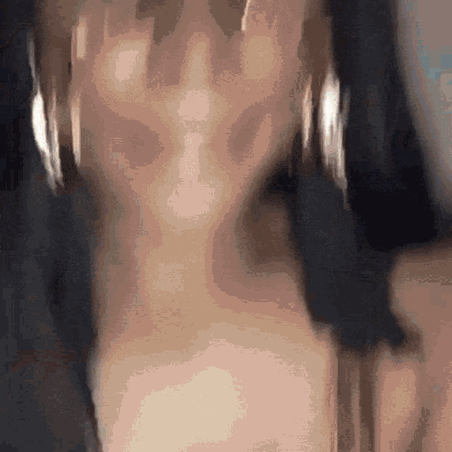 a close up of a woman 's face with a blurry background