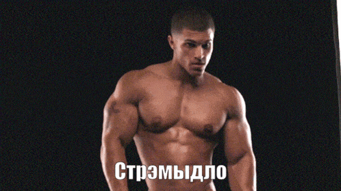 a shirtless man stands in front of a black background with a foreign language written on the bottom