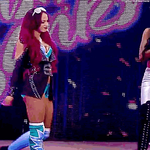 a woman with red hair is standing on a stage .